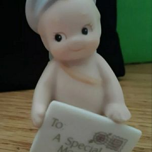 Kewpie doll mail carrier with letter